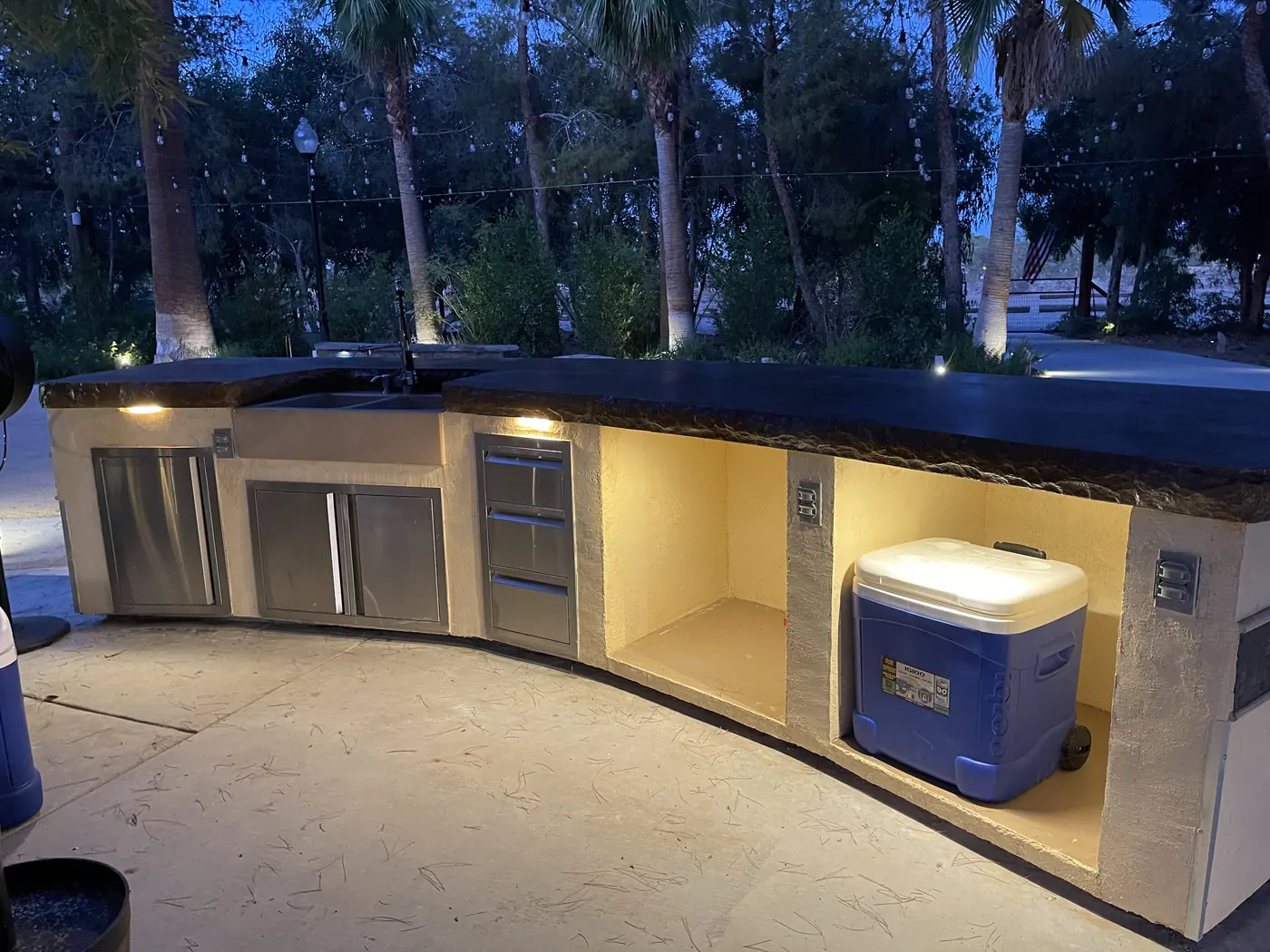A built-in wet bar glowing at night at The Garden