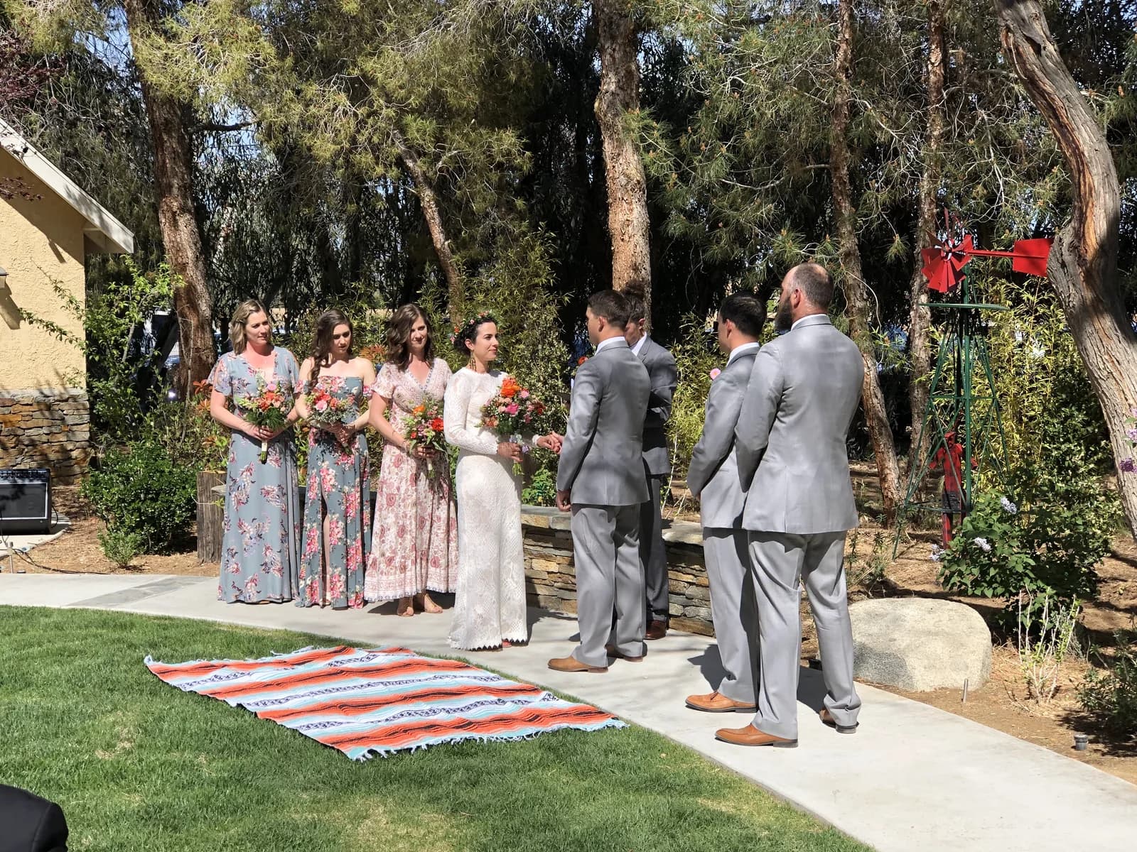An outdoor ceremony on the lawn beneath the pines