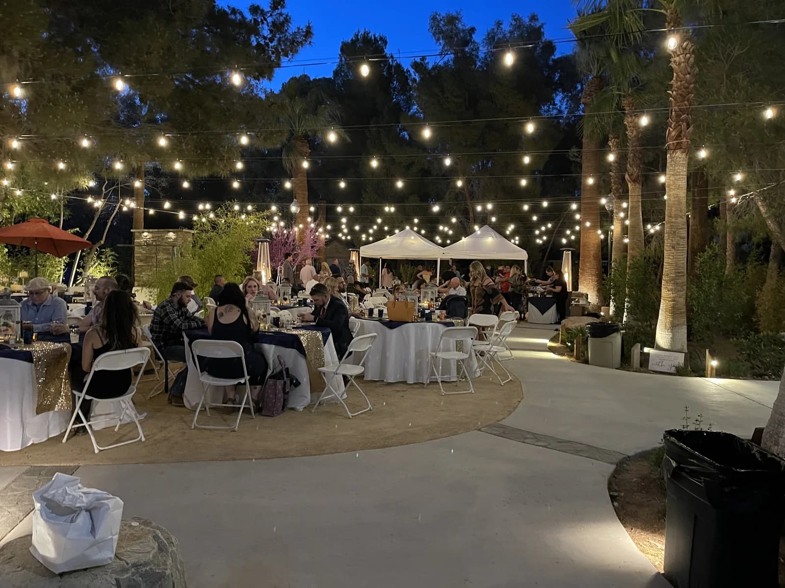 A dusk reception under strings of bistro lights